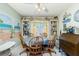 Cozy dining room featuring a round table, comfortable wooden chairs, and charming decor, creating a warm and inviting atmosphere at 6103 Fabian Rd, North Port, FL 34287
