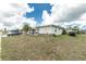 Charming single-story home featuring a well-maintained lawn and a clean exterior, with ample parking space in the driveway at 6103 Fabian Rd, North Port, FL 34287