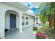 Inviting front porch featuring a stylish blue door and decorative planters, creating a welcoming entrance to the home at 6103 Fabian Rd, North Port, FL 34287