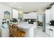 Bright kitchen with a breakfast bar, white cabinets, and an open layout that seamlessly connects to the adjacent dining area at 6103 Fabian Rd, North Port, FL 34287