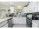 Well-lit kitchen featuring white cabinetry, modern appliances, and a functional layout, perfect for cooking and meal preparation at 6103 Fabian Rd, North Port, FL 34287
