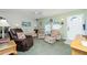 Cozy living room with large windows, comfortable seating, and plenty of natural light at 6103 Fabian Rd, North Port, FL 34287