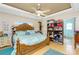 Bright main bedroom with neutral walls, wood flooring, and dresser with decor at 6103 Fabian Rd, North Port, FL 34287