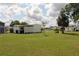 Well-maintained backyard featuring a lush lawn and mature landscaping at 6843 Amoko Ct, North Port, FL 34287