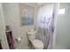Cozy bathroom features a shower, toilet and wall art at 6843 Amoko Ct, North Port, FL 34287