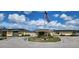 Inviting community clubhouse showcasing manicured landscaping and ample parking at 6843 Amoko Ct, North Port, FL 34287