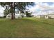 Lush green space with mature trees and landscaping, perfect for outdoor activities at 6843 Amoko Ct, North Port, FL 34287