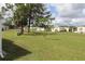 A sprawling lawn area with mature trees and landscaping throughout the community at 6843 Amoko Ct, North Port, FL 34287