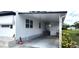 Exterior side view showing carport and home details at 6843 Amoko Ct, North Port, FL 34287