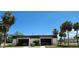 Community library and recreation center with manicured landscaping and ample parking at 6843 Amoko Ct, North Port, FL 34287