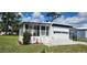 Attractive single-story home boasts a cozy sunroom and manicured front lawn at 6843 Amoko Ct, North Port, FL 34287