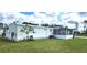 The home features a sunroom and a well-maintained lawn, offering a tranquil outdoor space at 6843 Amoko Ct, North Port, FL 34287
