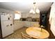 Functional kitchen with white cabinetry and appliances, complemented by a breakfast nook and view to the living area at 6843 Amoko Ct, North Port, FL 34287