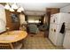Open kitchen layout adjacent to living room and breakfast nook featuring refrigerator and gas range oven at 6843 Amoko Ct, North Port, FL 34287