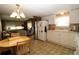 Well-organized kitchen with white appliances, a breakfast nook, and a seamless connection to the living room at 6843 Amoko Ct, North Port, FL 34287