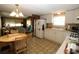 Efficient kitchen featuring white cabinetry, essential appliances, and an adjacent breakfast area overlooking the living room at 6843 Amoko Ct, North Port, FL 34287