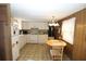 Bright kitchen with white appliances, ample cabinet space, and a cozy breakfast nook area for casual dining at 6843 Amoko Ct, North Port, FL 34287