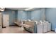 Well-maintained laundry room with multiple washers and dryers at 6843 Amoko Ct, North Port, FL 34287