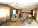 Inviting living room with wood-look floors and comfortable seating, adjacent to a kitchen area for easy entertaining at 6843 Amoko Ct, North Port, FL 34287