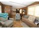 Comfortable living room featuring a neutral color palette, wood-look floors, and ample seating, open to the kitchen at 6843 Amoko Ct, North Port, FL 34287