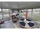 Enclosed sunroom with tile flooring and glass windows offering natural light and views of the surrounding neighborhood at 6843 Amoko Ct, North Port, FL 34287
