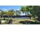 Scenic tennis court surrounded by lush landscaping, offering a great recreational opportunity at 6843 Amoko Ct, North Port, FL 34287