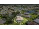 Aerial shot of a home with a pool, set in a well-manicured community with lush landscaping and a nearby lake at 7101 Dogwood Ct, North Port, FL 34287