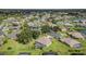 Expansive aerial view of a neighborhood showcasing well-maintained homes, green lawns and a large lake at 7101 Dogwood Ct, North Port, FL 34287