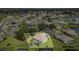 Aerial shot of a home with a pool, set in a well-manicured community with lush landscaping and a nearby lake at 7101 Dogwood Ct, North Port, FL 34287