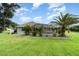 Lush backyard showcasing a screened pool, mature trees, and meticulously manicured lawn at 7101 Dogwood Ct, North Port, FL 34287
