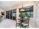 Bright breakfast nook with a round table and chairs, offering views of the outdoor living space and pool at 7101 Dogwood Ct, North Port, FL 34287