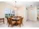 Cozy dining area with a glass-top table, seating for six, and ample natural light from a large window at 7101 Dogwood Ct, North Port, FL 34287