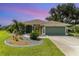 Charming single-story home with well-manicured lawn, beautiful landscaping, and an attached garage at 7101 Dogwood Ct, North Port, FL 34287