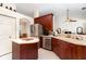 Functional kitchen area with wooden cabinets, stainless steel appliances, and a breakfast bar with seating at 7101 Dogwood Ct, North Port, FL 34287