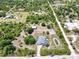 Serene aerial view of sprawling property featuring lush greenery, a peaceful pond, and well-maintained landscaping at 7274 Alan Blvd, Punta Gorda, FL 33982