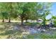 Lush backyard featuring mature trees, landscaping, and partial fencing, perfect for outdoor enjoyment at 7274 Alan Blvd, Punta Gorda, FL 33982
