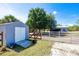 Spacious shed with gray doors, a wooden ramp, and views of the fenced backyard with a barn at 7274 Alan Blvd, Punta Gorda, FL 33982
