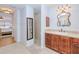 Bathroom features tile floors, vanity with custom mirror and granite countertop, and a walk-in shower at 7274 Alan Blvd, Punta Gorda, FL 33982