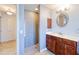 Bathroom features tile floors, vanity with custom mirror and countertop, and a walk-in tiled shower at 7274 Alan Blvd, Punta Gorda, FL 33982