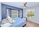 Bright bedroom with a large bay window, ceiling fan, wood floors, and calming paint colors at 7274 Alan Blvd, Punta Gorda, FL 33982