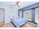 Comfortable bedroom with a large bay window, ceiling fan, wood floors, and a pink patterned rug at 7274 Alan Blvd, Punta Gorda, FL 33982