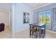 Charming dining room with a modern table, chandelier, and large window with sheer curtains at 7274 Alan Blvd, Punta Gorda, FL 33982