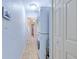 Hallway features tile flooring, laundry closet with stacked washer/dryer, and access to other rooms at 7274 Alan Blvd, Punta Gorda, FL 33982