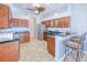 Spacious kitchen featuring dark wood cabinets, stainless appliances, and a breakfast bar with seating at 7274 Alan Blvd, Punta Gorda, FL 33982