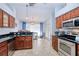 Modern kitchen featuring stainless steel appliances, dark wood cabinets, and tile flooring at 7274 Alan Blvd, Punta Gorda, FL 33982