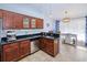 Well-equipped kitchen with stainless steel appliances, granite countertops, and rich wood cabinetry at 7274 Alan Blvd, Punta Gorda, FL 33982