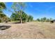 Expansive land featuring scattered trees, open pasture, and clear blue sky, offering potential for development or recreation at 7274 Alan Blvd, Punta Gorda, FL 33982