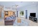 Comfortable living room with tile floors, ceiling fan and French doors leading to outdoor area at 7274 Alan Blvd, Punta Gorda, FL 33982