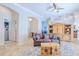 Bright living room featuring tile floors, a ceiling fan, and a cozy couch with patterned pillows at 7274 Alan Blvd, Punta Gorda, FL 33982