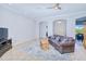 Spacious living room featuring tile flooring, a ceiling fan, and an archway leading to other rooms at 7274 Alan Blvd, Punta Gorda, FL 33982